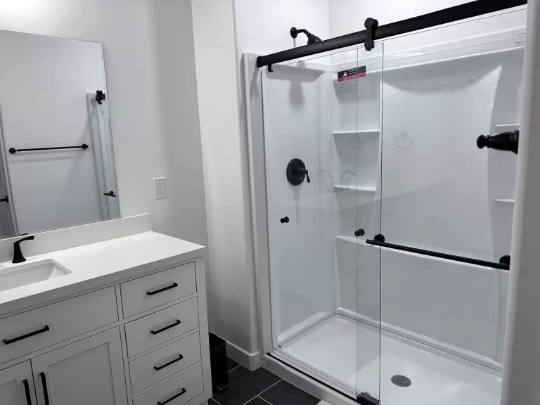 Utah Basement Finishing- bathroom with an upgrade shower kit and a glass door