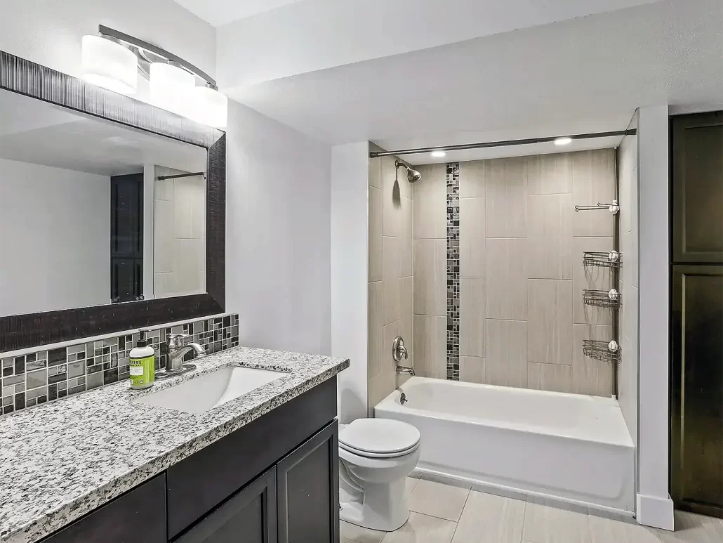 Basement Bathroom with a tile shower and a 60 inch vanity